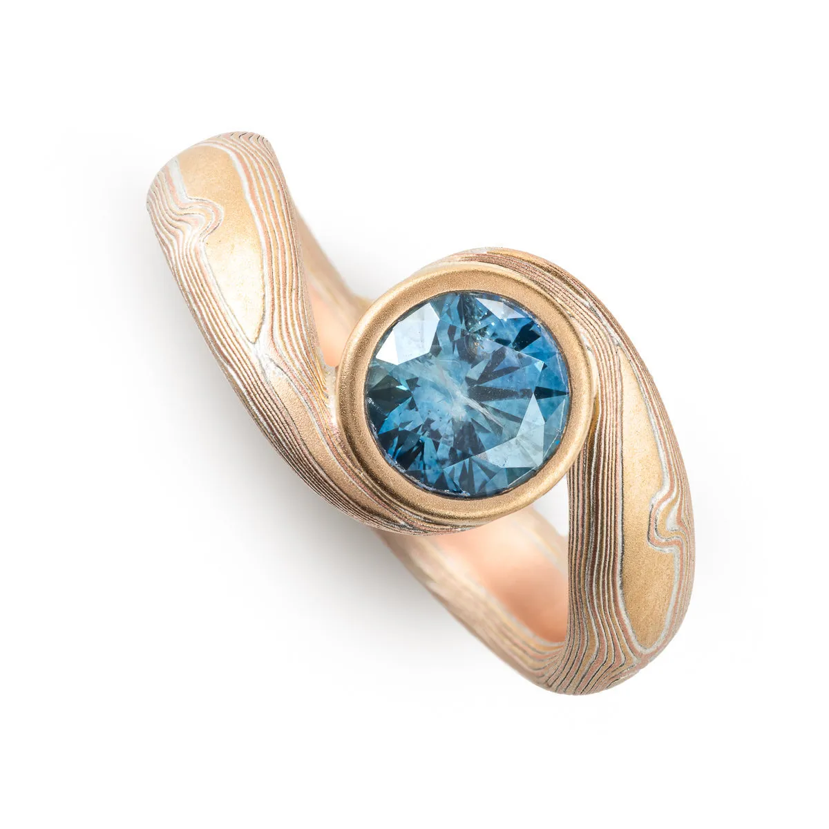 Teal Sapphire Bypass Ring in Woodgrain Pattern and Fire Palette