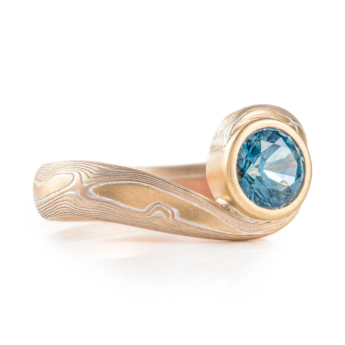 Teal Sapphire Bypass Ring in Woodgrain Pattern and Fire Palette