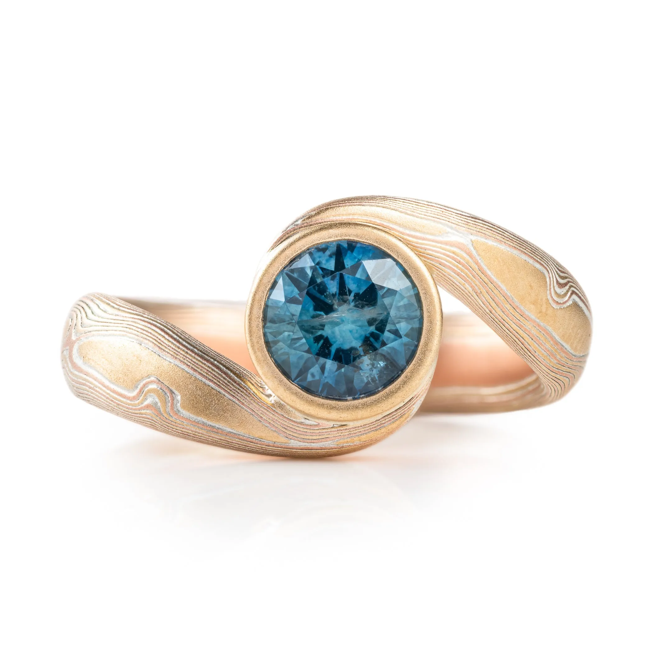 Teal Sapphire Bypass Ring in Woodgrain Pattern and Fire Palette